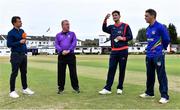 27 July 2022; Mark Adair of Northern Knights performs the coin toss alongside, from left, commentator Andrew Blair White of HBV Studios, third umpire Jareth McCready and Andy McBrine of North West Warriors before the Cricket Ireland Inter-Provincial Trophy match between Northern Knights and North West Warriors at Pembroke Cricket Club in Dublin. Photo by Piaras Ó Mídheach/Sportsfile