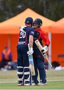 27 July 2022; Ross Adair of Northern Knights, left, celebrates with teammate Cade Carmichael after bringing up his century during the Cricket Ireland Inter-Provincial Trophy match between Northern Knights and North West Warriors at Pembroke Cricket Club in Dublin. Photo by Piaras Ó Mídheach/Sportsfile