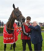 27 July 2022; President of Ireland Michael D Higgins with winning groom Paddy Hanlon, son of trainer John Hanlon, and Hewick after the Tote Galway Plate during day three of the Galway Races Summer Festival at Ballybrit Racecourse in Galway. Photo by Seb Daly/Sportsfile
