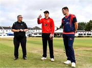 28 July 2022; Munster Red's captain PJ Moor makes the toss, watched by match referee Phil Thompson, left, and Northern Knights captain Mark Adair during the Cricket Ireland Inter-Provincial Trophy match between Munster Reds and Northern Knights at Pembroke Cricket Club in Dublin. Photo by Sam Barnes/Sportsfile