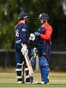 28 July 2022; James McCollum, right, and John Matchett, both of Northern Knights, bump fists during the Cricket Ireland Inter-Provincial Trophy match between Munster Reds and Northern Knights at Pembroke Cricket Club in Dublin. Photo by Sam Barnes/Sportsfile
