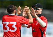 28 July 2022; Murray Commins of Munster Reds, right, celebrates with team-mate Liam McCarthy after catching out James McCollum of Northern Knights during the Cricket Ireland Inter-Provincial Trophy match between Munster Reds and Northern Knights at Pembroke Cricket Club in Dublin. Photo by Sam Barnes/Sportsfile