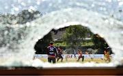 28 July 2022; A view through a broken window as Curtis Campher of Munster Reds plays a shot watched by Northern Knights wicketkeeper Neil Rock during the Cricket Ireland Inter-Provincial Trophy match between Munster Reds and Northern Knights at Pembroke Cricket Club in Dublin. Photo by Sam Barnes/Sportsfile