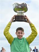 28 July 2022; Jockey Liam McKenna celebrates with the trophy after riding Tudor City to victory in the Guinness Galway Hurdle Handicap during day four of the Galway Races Summer Festival at Ballybrit Racecourse in Galway. Photo by Seb Daly/Sportsfile