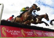 28 July 2022; Tudor City, with Liam McKenna up, jump the fourth on their way to winning the Guinness Galway Hurdle Handicap during day four of the Galway Races Summer Festival at Ballybrit Racecourse in Galway. Photo by Seb Daly/Sportsfile