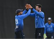 28 July 2022; Simi Singh of Leinster Lightning celebrates with team-mate George Dockrell after catching out Stephen Doheny of North West Warriors during the Cricket Ireland Inter-Provincial Trophy match between Leinster Lightning and North West Warriors at Pembroke Cricket Club in Dublin. Photo by Sam Barnes/Sportsfile