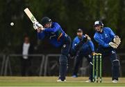 28 July 2022; Scott Macbeth of North West Warriors plays  a shot watched by Leinster Lightning wicketkeeper Lorcan Tucker during the Cricket Ireland Inter-Provincial Trophy match between Leinster Lightning and North West Warriors at Pembroke Cricket Club in Dublin. Photo by Sam Barnes/Sportsfile