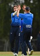 28 July 2022; Gavin Hoey of Leinster Lightning, left, is congratulated by team-mate Mike O'Reilly after bowling Jared Wilson of North West Warriors during the Cricket Ireland Inter-Provincial Trophy match between Leinster Lightning and North West Warriors at Pembroke Cricket Club in Dublin. Photo by Sam Barnes/Sportsfile
