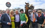28 July 2022; Winning connections, including owner John Breslin, left, trainer Tony Martin, third from left, and jockey Liam McKenna, with Tudor City after winning the Guinness Galway Hurdle Handicap during day four of the Galway Races Summer Festival at Ballybrit Racecourse in Galway. Photo by Seb Daly/Sportsfile