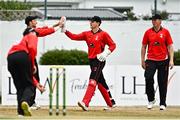 29 July 2022; Munster Reds wicketkeeper PJ Moor, centre, celebrates with team-mates after catching out Nathan McGuire of North West Warriors during the Cricket Ireland Inter-Provincial Trophy match between North West Warriors and Munster Reds at Pembroke Cricket Club in Dublin. Photo by Sam Barnes/Sportsfile