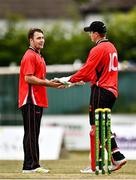 29 July 2022; Curtis Campher of Munster Reds, left, and team-mate PJ Moor celebrate the wicket of Andy McBrine of North West Warriors during the Cricket Ireland Inter-Provincial Trophy match between North West Warriors and Munster Reds at Pembroke Cricket Club in Dublin. Photo by Sam Barnes/Sportsfile