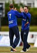 29 July 2022; Graham Kennedy of North West Warriors, left, is congratulated by team-mate Andy McBrine after catching out Murray Commins of Munster Reds during the Cricket Ireland Inter-Provincial Trophy match between North West Warriors and Munster Reds at Pembroke Cricket Club in Dublin. Photo by Sam Barnes/Sportsfile