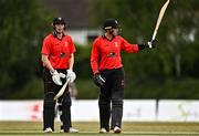 29 July 2022; PJ Moor of Munster Reds, right, is congratulated by team-mate Gareth Delany after bringing up his half century during the Cricket Ireland Inter-Provincial Trophy match between North West Warriors and Munster Reds at Pembroke Cricket Club in Dublin. Photo by Sam Barnes/Sportsfile