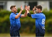 29 July 2022; Barry McCarthy of Leinster Lightning, left, celebrates with team-mate Josh Little after bowling James McCollum of Northern Knights during the Cricket Ireland Inter-Provincial Trophy match between Northern Knights and Leinster Lightning at Pembroke Cricket Club in Dublin. Photo by Sam Barnes/Sportsfile