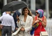 29 July 2022; Racegoers shelter from the rain prior to racing on day five of the Galway Races Summer Festival at Ballybrit Racecourse in Galway. Photo by Seb Daly/Sportsfile