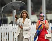 29 July 2022; Racegoers shelter from the rain prior to racing on day five of the Galway Races Summer Festival at Ballybrit Racecourse in Galway. Photo by Seb Daly/Sportsfile