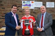 30 July 2022; Kilkerrin Clonberne captain Louise Ward, from Galway, is presented with the cup by Uachtarán Cumann Peil Gael na mBan, Mícheál Naughton, left, and currentaccount.ie chief executive officer Seamus Newcombe after the Currentaccount.ie All-Ireland Ladies Football Senior Club 7-a-side championship final at Naomh Mearnóg's GAA club in Dublin. Photo by Brendan Moran/Sportsfile