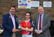 30 July 2022; Donaghmoyne captain Cora Courtney, from Monaghan, is presented with the shield by Uachtarán Cumann Peil Gael na mBan, Mícheál Naughton, left, and currentaccount.ie chief executive officer Seamus Newcombe after the Currentaccount.ie All-Ireland Ladies Football Senior Club 7-a-side shield final at Naomh Mearnóg's GAA club in Dublin. Photo by Brendan Moran/Sportsfile