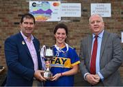 30 July 2022; Parnells captain Renee Murphy, from London, is presented with the cup by Uachtarán Cumann Peil Gael na mBan, Mícheál Naughton, left, and currentaccount.ie chief executive officer Seamus Newcombe after the Currentaccount.ie All-Ireland Ladies Football Intermediate Club 7-a-side championship final at Naomh Mearnóg's GAA club in Dublin. Photo by Brendan Moran/Sportsfile