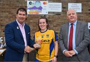 30 July 2022; Carrickedmond captain Michelle Noonan, from Longford, is presented with her runners-up trophy by Uachtarán Cumann Peil Gael na mBan, Mícheál Naughton, left, and currentaccount.ie chief executive officer Seamus Newcombe after the Currentaccount.ie All-Ireland Ladies Football Intermediate Club 7-a-side championship final at Naomh Mearnóg's GAA club in Dublin. Photo by Brendan Moran/Sportsfile
