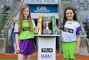 31 July 2022; Cup carriers Cadhla Morris and Evie Miller carry the West County Hotel cup onto the pitch before the TG4 All-Ireland Ladies Football Junior Championship Final match between Antrim and Fermanagh at Croke Park in Dublin. Photo by Brendan Moran/Sportsfile