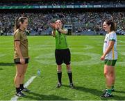 31 July 2022; Referee Maggie Farrelly performs the coin toss in the company of team captains Anna Galvin of Kerry and Shauna Ennis of Meath before the TG4 All-Ireland Ladies Football Senior Championship Final match between Kerry and Meath at Croke Park in Dublin. Photo by Brendan Moran/Sportsfile