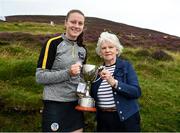 1 August 2022; Lucy Lynch of Cork is presented the under-16 trophy by Ulster Camogie chairperson Deidre McGrath after the M. Donnelly GAA All-Ireland Poc Fada Finals at Cooley Mountains in Louth. Photo by Harry Murphy/Sportsfile