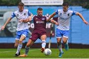1 August 2022; Dane Massey of Drogheda United in action against Alex Nolan, left, and Thomas Lonergan of UCD during the SSE Airtricity League Premier Division match between Drogheda United and UCD at Head in the Game Park in Drogheda, Louth. Photo by Ben McShane/Sportsfile