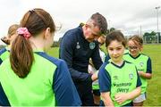 2 August 2022; Republic of Ireland manager Stephen Kenny signs a jersey for Amaya Kate Matsushita during a visit to the INTERSPORT Elverys Summer Soccer Schools at Tullamore Town FC in Leah Victoria Park, Tullamore, Offaly. Photo by Harry Murphy/Sportsfile