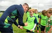2 August 2022; Republic of Ireland manager Stephen Kenny signs a jersey for Jack Smyth during a visit to the INTERSPORT Elverys Summer Soccer Schools at Tullamore Town FC in Leah Victoria Park, Tullamore, Offaly. Photo by Harry Murphy/Sportsfile