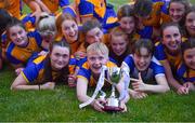 3 August 2022; Katie Callaghan of Clare, centre, and her teammates celebrate with the cup after their side's victory in the ZuCar All-Ireland Ladies Football Minor ‘C’ Championship Final match between Clare and Wicklow at Kinnegad GAA club in Kinnegad, Westmeath. Photo by Piaras Ó Mídheach/Sportsfile