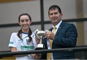 3 August 2022; LGFA President Mícheál Naughton presents the trophy to Holly McQuaid of Monaghan after the ZuCar All-Ireland Ladies Football Minor B Championship Final match between Monaghan and Longford at Donaghmore Ashbourne GAA club in Ashbourne, Meath. Photo by David Fitzgerald/Sportsfile