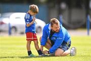 4 August 2022; Emanuela Spagnoli has his laces tied by coach Alex Holmes during the Bank of Ireland Leinster Rugby Summer Camp at St Mary's College RFC in Dublin. Photo by Ben McShane/Sportsfile
