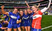 31 July 2022; Laois players, from left, Anna Healy, Orla Hennessy, Ellen Healy and goalkeeper Eimear Barry celebrate with selector Martina Phelan after their side's victory in the TG4 All-Ireland Ladies Football Intermediate Championship Final match between Laois and Wexford at Croke Park in Dublin. Photo by Piaras Ó Mídheach/Sportsfile