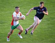 5 August 2022; Leon Young of Ballymun Kickhams in action against Nathan Doran of Clontarf during the Dublin Senior Club Football Championship Group 2 match between Ballymun Kickhams and Clontarf at Parnell Park in Dublin. Photo by Piaras Ó Mídheach/Sportsfile