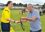 6 August 2022; Assistant referee Ruben Collins is presented with his medal by FAI youth and amateur committee member Dave Moran after the FAI Women's Angela Hearst InterLeague Cup Final match between Wexford & District Women's League and Eastern Women's Football League at Arklow Town FC, in Wicklow. Photo by Seb Daly/Sportsfile