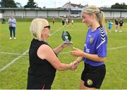 6 August 2022; Katie Murphy of Wexford & District Women's League is presented with her Player of the Match award by Ebbie Hearst after the FAI Women's Angela Hearst InterLeague Cup Final match between Wexford & District Women's League and Eastern Women's Football League at Arklow Town FC, in Wicklow. Photo by Seb Daly/Sportsfile