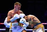 6 August 2022; Kurt Walker, left, and Marcos Gabriel Martinez during their featherweight bout at SSE Arena in Belfast. Photo by Ramsey Cardy/Sportsfile