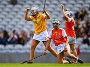 7 August 2022; Dervla Cosgrove of Antrim celebrates scoring her side's third goal, as Nicola Woods of Armagh, front, looks on during the Glen Dimplex All-Ireland Premier Junior Camogie Championship Final match between Antrim and Armagh at Croke Park in Dublin. Photo by Piaras Ó Mídheach/Sportsfile