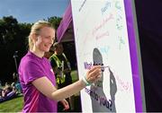 8 August 2022; Participants sign the community wall after the Tymon parkrun where Vhi hosted a special event to celebrate their More Than Running campaign. Vhi ambassador and Olympian David Gillick was on hand to lead the warm up for parkrun participants and is calling on people to attend a parkrun near you this summer and build it into their weekly routines by either walking, jogging, running or volunteering. parkruns have proved to improve participants fitness levels, along with physical heath, happiness and mental health. parkrun in partnership with Vhi support local communities in organising free, weekly, timed 5km runs every Saturday at 9.30am. To register for a parkrun near you visit www.parkrun.ie.  Photo by Seb Daly/Sportsfile
