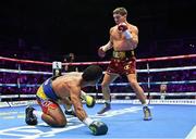 6 August 2022; Michael Conlan knocks down Miguel Marriaga during their featherweight bout at SSE Arena in Belfast. Photo by Ramsey Cardy/Sportsfile