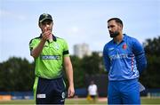 9 August 2022; Ireland captain Andrew Balbirnie, left, performs the coin toss in the company of Afghanistan captain Mohammad Nabi before the Men's T20 International match between Ireland and Afghanistan at Stormont in Belfast. Photo by Ramsey Cardy/Sportsfile