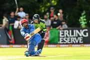 9 August 2022; Usman Ghani of Afghanistan hits a four during the Men's T20 International match between Ireland and Afghanistan at Stormont in Belfast. Photo by Ramsey Cardy/Sportsfile
