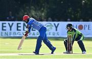 11 August 2022; Mohammad Nabi of Afghanistan plays a shot watched by Ireland wicketkeeper Lorcan Tucker during the Men's T20 International match between Ireland and Afghanistan at Stormont in Belfast. Photo by Sam Barnes/Sportsfile
