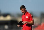 11 August 2022; Ben McCormack of St Patrick's Athletic reads a match programme before the UEFA Europa Conference League third qualifying round second leg match between St Patrick's Athletic and CSKA Sofia at Tallaght Stadium in Dublin. Photo by Harry Murphy/Sportsfile