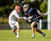 11 August 2022; Christopher First of USA is tackled by Daniel Flisk of England during the 2022 World Lacrosse Men's U21 World Championship - Group A match between USA and England at the University of Limerick in Limerick. Photo by Tom Beary/Sportsfile