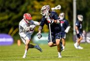 11 August 2022; Cole Kirst of USA is tackled by Daniel Flisk of England during the 2022 World Lacrosse Men's U21 World Championship - Group A match between USA and England at the University of Limerick in Limerick. Photo by Tom Beary/Sportsfile