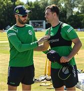 12 August 2022; Ireland captain Andrew Balbirnie, left, presents Fionn Hand of Ireland with his cap before the Men's T20 International match between Ireland and Afghanistan at Stormont in Belfast. Photo by Ramsey Cardy/Sportsfile