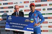 12 August 2022; Rahmanullah Gurbaz of Afghanistan is presented with the multibagger of the match cheque by Cricket Ireland president David Griffin after the Men's T20 International match between Ireland and Afghanistan at Stormont in Belfast. Photo by Ramsey Cardy/Sportsfile