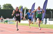 13 August 2022; Finbarr Whelan of Liscarroll AC, right, and Neil Kingston of Eagle AC dip for the line whilst competing in the men's vet50 100 metres  during the Irish Life Health National Masters Track and Field Championships in Tullamore, Offaly. Photo by Seb Daly/Sportsfile